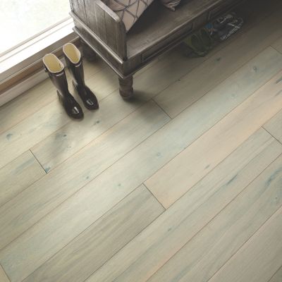 hardwood flooring in an entryway with a bench and rain boots